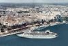 Vista aérea puerto de Mahon un buques hace maniobras para atracar, el ferry de acciona (trasmediterranea) esta frente a la estacion de pasajeros, estacion maritima de Mao